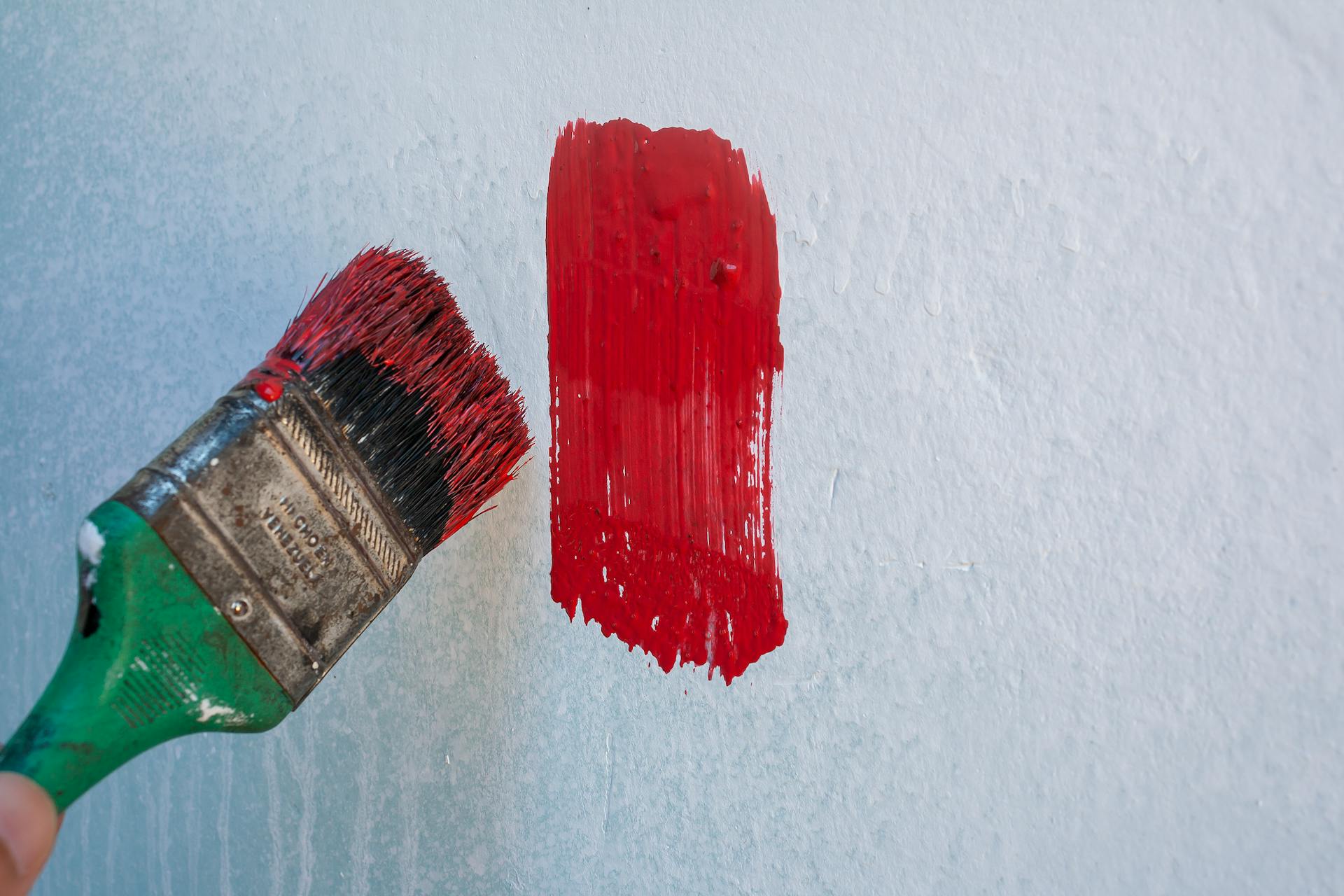 Red Paintbrush on Wall